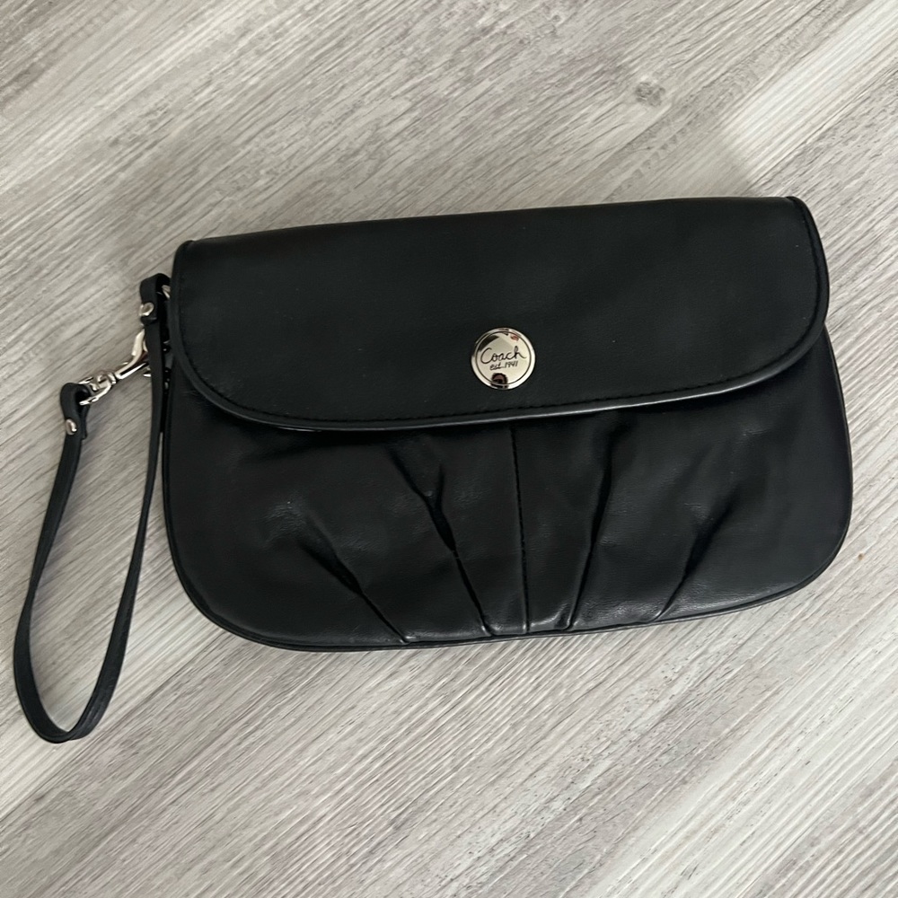 Small coach clutch with wristlet strap